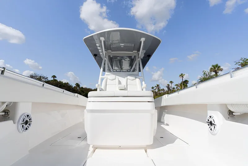 Slide: The Image of 2024 Invincible 33 Open Fisherman boat, sleek design, clear sky, palm trees in background. - 19