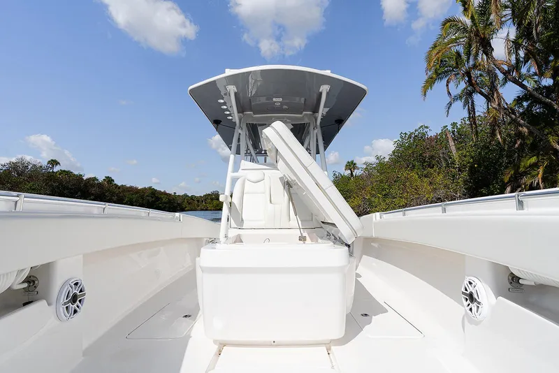 Slide: The Image of 2024 Invincible 33 Open Fisherman boat with open deck and seating, under clear blue sky. - 20