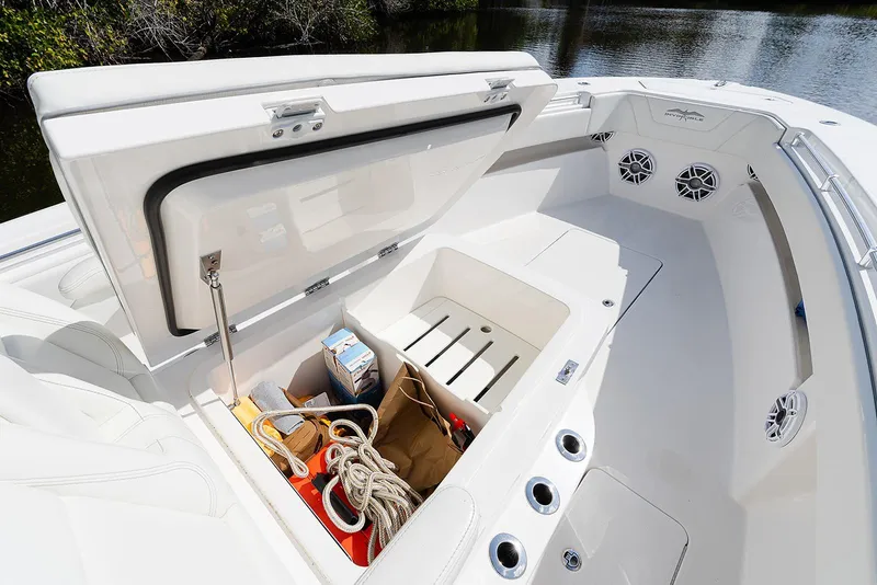 Slide: The Image of 2024 Invincible 33 Open Fisherman boat storage compartment with ropes and supplies. - 21