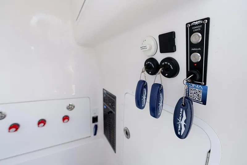 Slide: The Image of 2024 Invincible 33 Open Fisherman boat console with keys and control panel. - 25