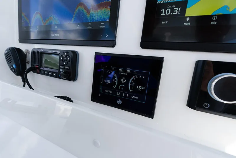 Slide: The Image of 2024 Invincible 33 Open Fisherman dashboard with advanced navigation and communication systems. - 28