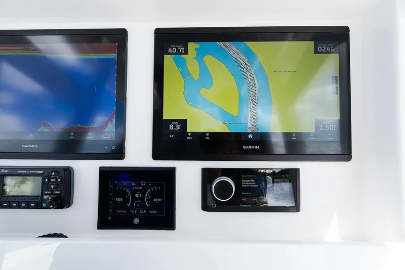 Slide: The Image of Dashboard of 2024 Invincible 33 Open Fisherman with Garmin navigation displays. - 29