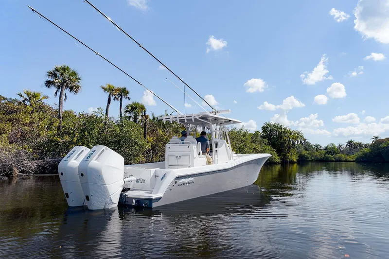 Slide: The Image of 2024 Invincible 33 Open Fisherman boat cruising on a scenic waterway. - 3