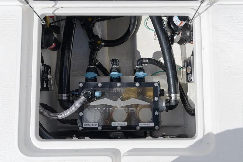 Slide: The Image of 2024 Invincible 33 Open Fisherman baitwell system with hoses and valves. - 31