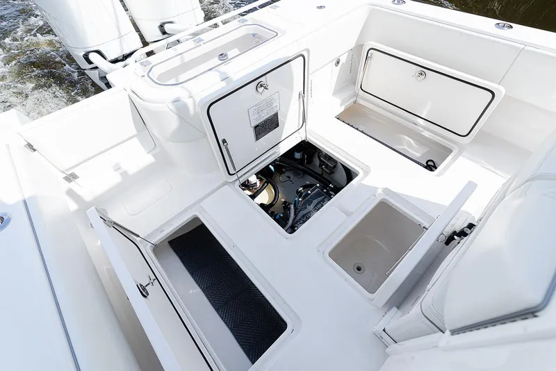 Slide: The Image of 2024 Invincible 33 Open Fisherman boat deck with storage compartments and engine access. - 34