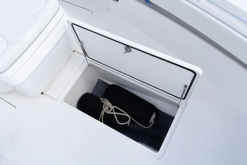 Slide: The Image of Open storage compartment on 2024 Invincible 33 Open Fisherman boat with fenders inside. - 36