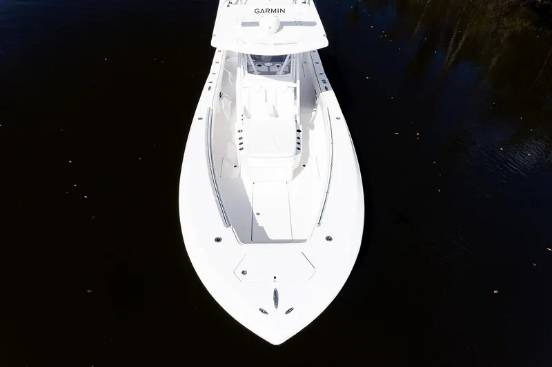 Slide: The Image of 2024 Invincible 33 Open Fisherman boat on calm water, aerial view. - 6