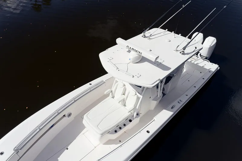 Slide: The Image of 2024 Invincible 33 Open Fisherman boat on calm water, aerial view. - 7