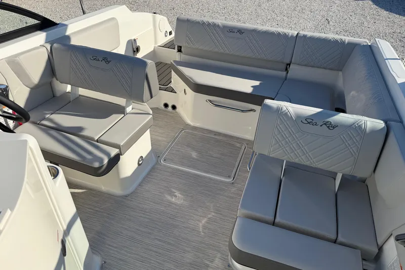 Slide: The Image of 2026 Sea Ray SDX 230 boat interior with gray seating and elegant design. - 14
