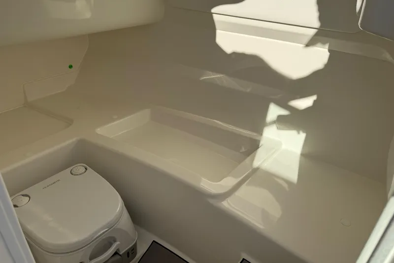 Slide: The Image of Interior of 2026 Sea Ray SDX 230 boat with compact toilet. - 17
