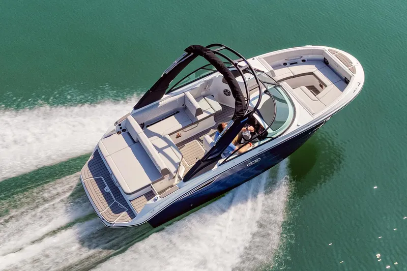 Slide: The Image of Manufacturer Provided Image: 2026 Sea Ray SDX 230 cruising on clear water, showcasing sleek design and spacious seating. - 21