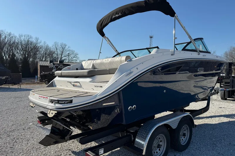Slide: The Image of 2026 Sea Ray SDX 230 boat on trailer, sleek design, blue and white exterior. - 3