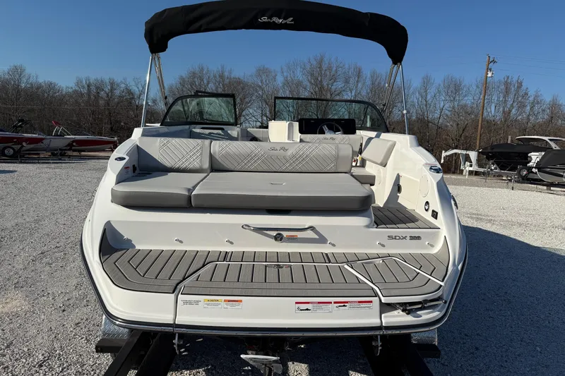 Slide: The Image of 2026 Sea Ray SDX 230 boat with sleek design and spacious seating, displayed outdoors. - 4