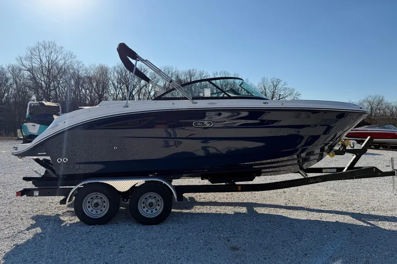 Slide: The Image of 2026 Sea Ray SDX 230 boat on trailer, parked outdoors on gravel. - 5