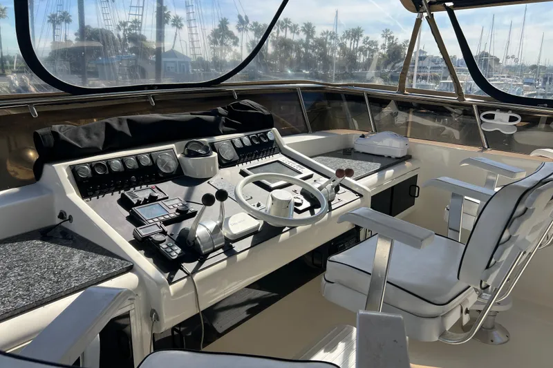 Slide: The Image of Control panel of a 1991 Viking 63 Motor Yacht with navigation instruments and steering wheel. - 12