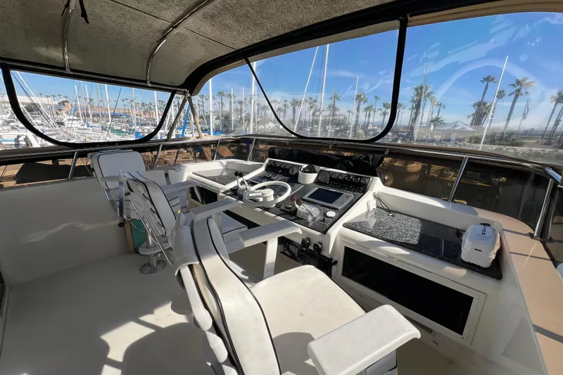 Slide: The Image of Cockpit of 1991 Viking 63 Motor Yacht with steering wheel and control panel. - 13
