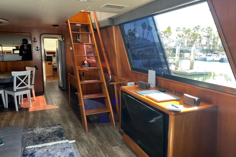 Slide: The Image of Luxurious interior of a 1991 Viking 63 Motor Yacht with modern furnishings and wood accents. - 18