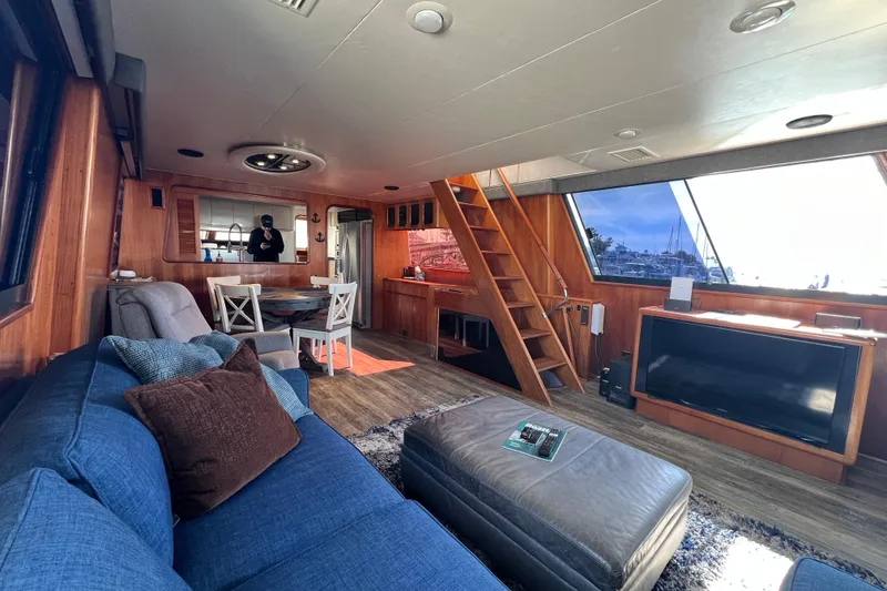 Slide: The Image of Interior of 1991 Viking 63 Motor Yacht with wooden decor and marina view. - 19