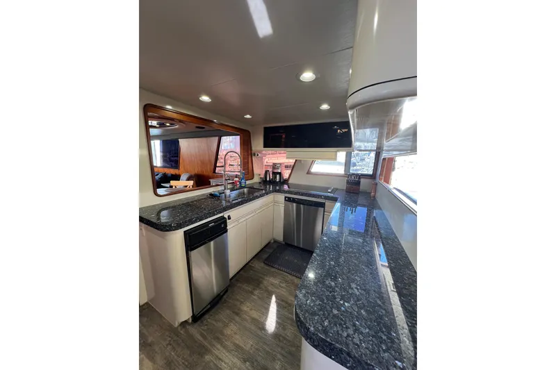 Slide: The Image of Luxurious interior of a 1991 Viking 63 Motor Yacht with modern furnishings and large windows. - 20