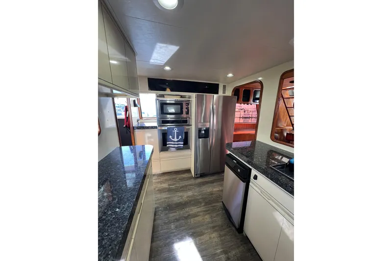 Slide: The Image of Luxurious kitchen interior of 1991 Viking 63 Motor Yacht with granite countertops. - 22