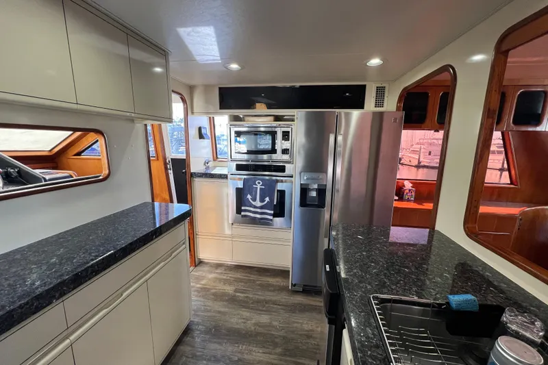 Slide: The Image of Modern kitchen interior of 1991 Viking 63 Motor Yacht with stainless steel appliances. - 23