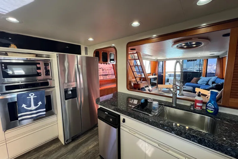 Slide: The Image of Luxurious kitchen interior of 1991 Viking 63 Motor Yacht with modern appliances. - 24