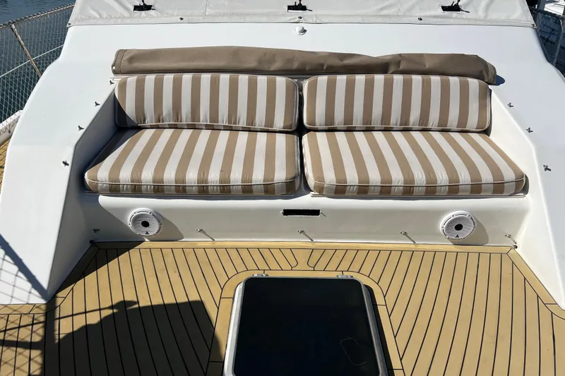 Slide: The Image of Deck of 1991 Viking 63 Motor Yacht with marina view, featuring equipment and safety netting. - 3