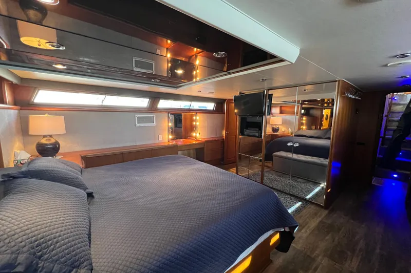 Slide: The Image of Master stateroom with walkaround King bed wit elegant wood finishes. - 31