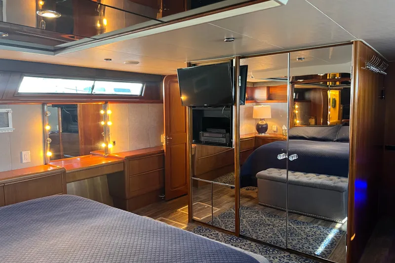 Slide: The Image of Luxurious bedroom interior of a 1991 Viking 63 Motor Yacht with elegant furnishings. - 32