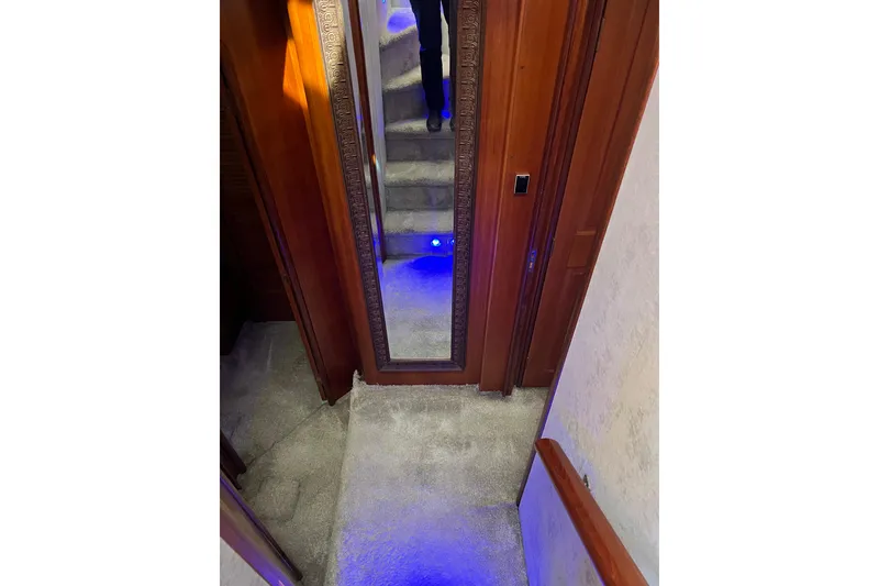 Slide: The Image of Interior staircase to forward guest berths with wooden paneling and artwork. - 38