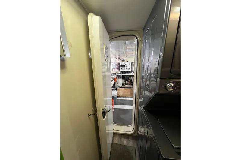 Slide: The Image of Laundry area outside of engineroom door access with stacked washer and dryer. - 50