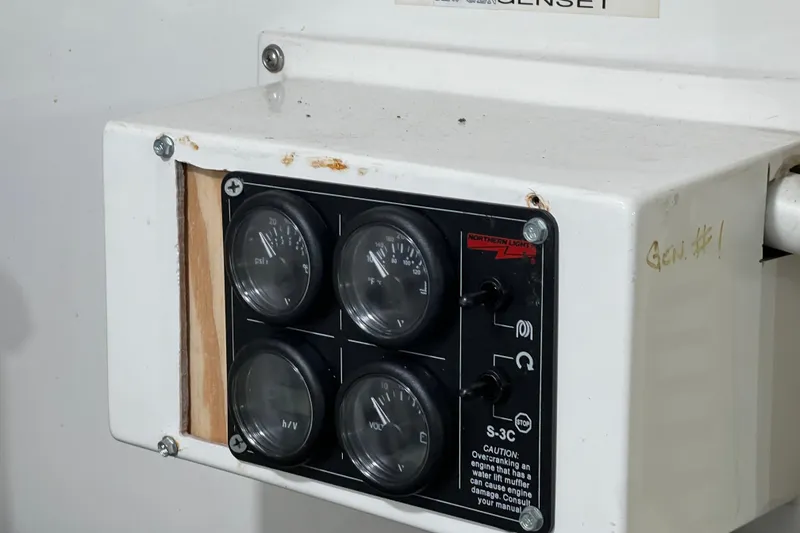 Slide: The Image of ProMariner ProNautic 12:60P charger on 1991 Viking 63 Motor Yacht, displaying voltage and amperage. - 58