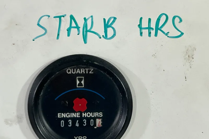 Slide: The Image of Control panel of a 1991 Viking 63 Motor Yacht with gauges and switches. - 59