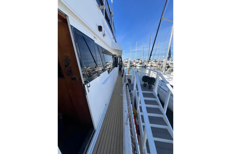 Slide: The Image of 1991 Viking 63 Motor Yacht docked in marina under clear blue sky. - 73
