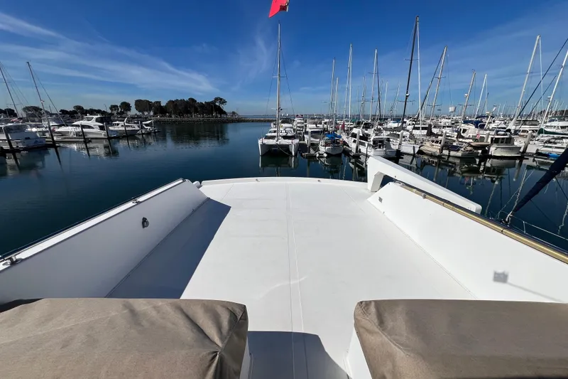Slide: The Image of 1991 Viking 63 Motor Yacht with sleek deck design and marina backdrop. - 8