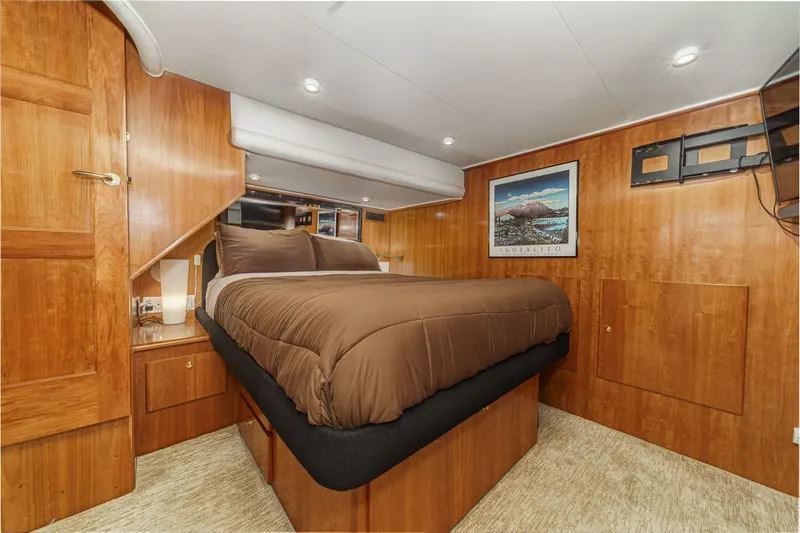 Slide: The Image of Luxurious bedroom in a 2001 Navigator 56 Classic yacht. - 3