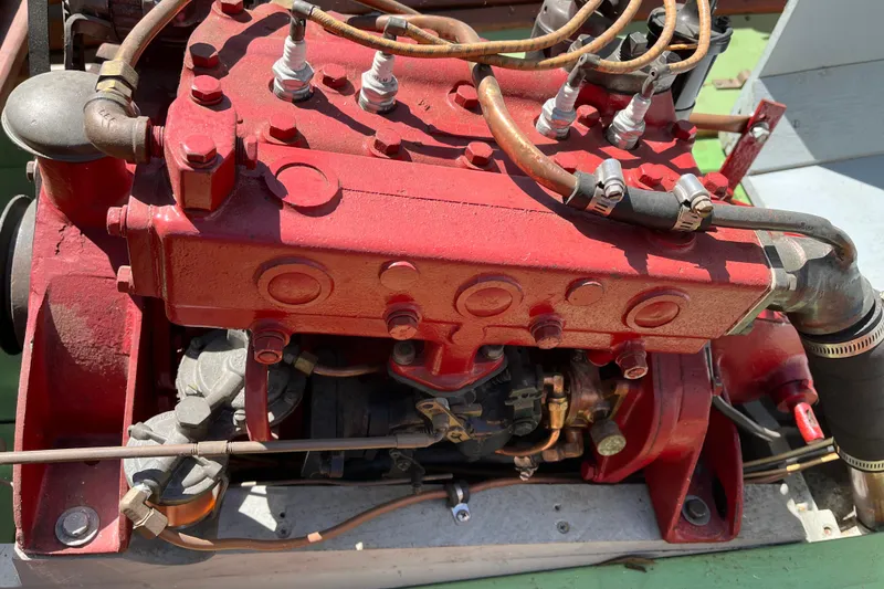 Slide: The Image of Red engine of a 1938 Yacht Tender with visible spark plugs and wiring. - 11