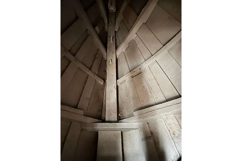 Slide: The Image of Interior view of a 1938 wooden yacht tender, showcasing its structural framework. - 15