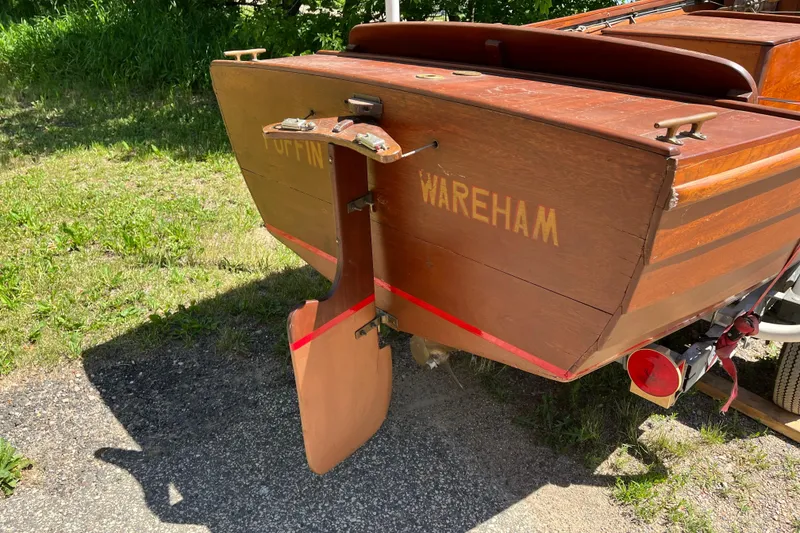 Slide: The Image of Vintage 1938 wooden yacht tender with "Puffin Wareham" inscription, displayed outdoors. - 4