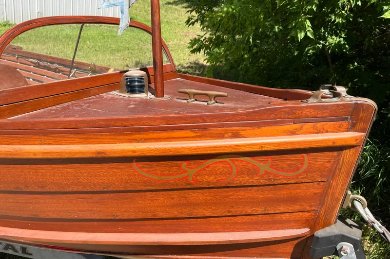 Slide: The Image of Vintage 1938 wooden yacht tender with decorative red accents and polished finish. - 6