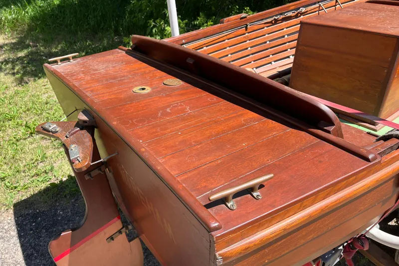 Slide: The Image of Vintage 1938 wooden yacht tender with polished deck and rudder, showcasing classic craftsmanship. - 8
