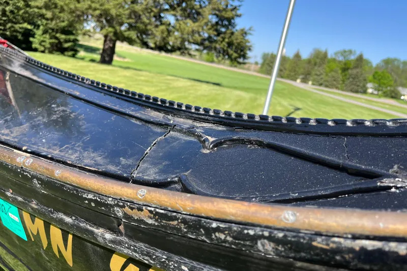 Slide: The Image of Cracked black surface of a 1985 GONDOLA utility model, outdoors on a sunny day. - 3