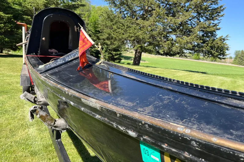 Slide: The Image of 1985 GONDOLA utility boat on grassy field with trees in background. - 4