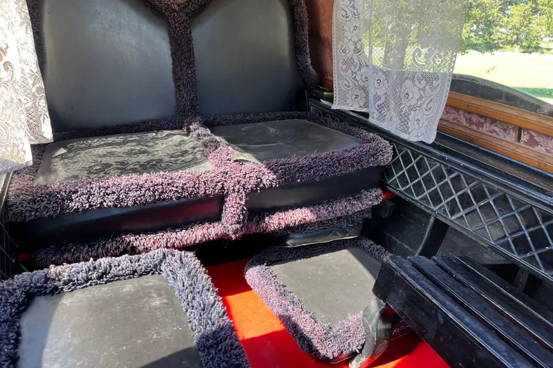 Slide: The Image of Interior of a 1985 GONDOLA utility vehicle with plush seating and lace curtains. - 6