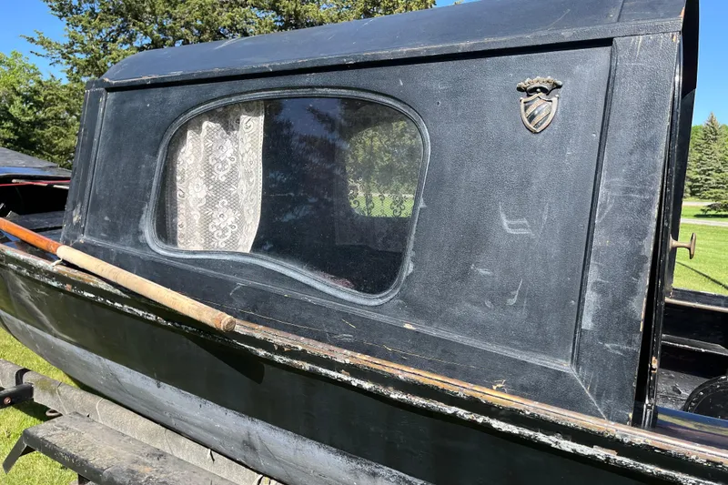 Slide: The Image of Vintage 1985 GONDOLA utility model with lace-curtained window and emblem, set outdoors. - 7