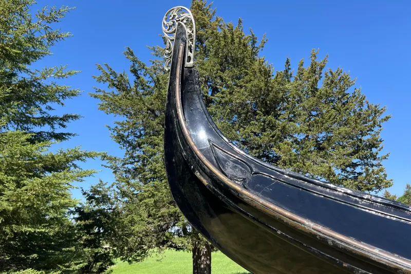 Slide: The Image of 1985 GONDOLA utility model against a clear blue sky and lush green trees. - 9