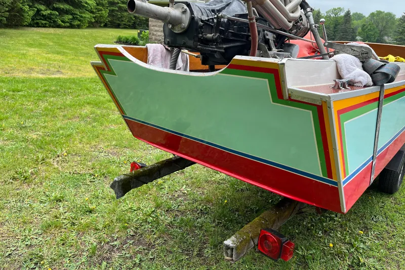 Slide: The Image of Colorful 1990 Thai Longboat utility model on grassy field, showcasing vibrant design. - 11