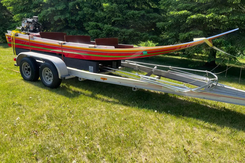 Slide: The Image of 1990 Utility Series Thai Longboat on trailer, parked on grassy area. - 3