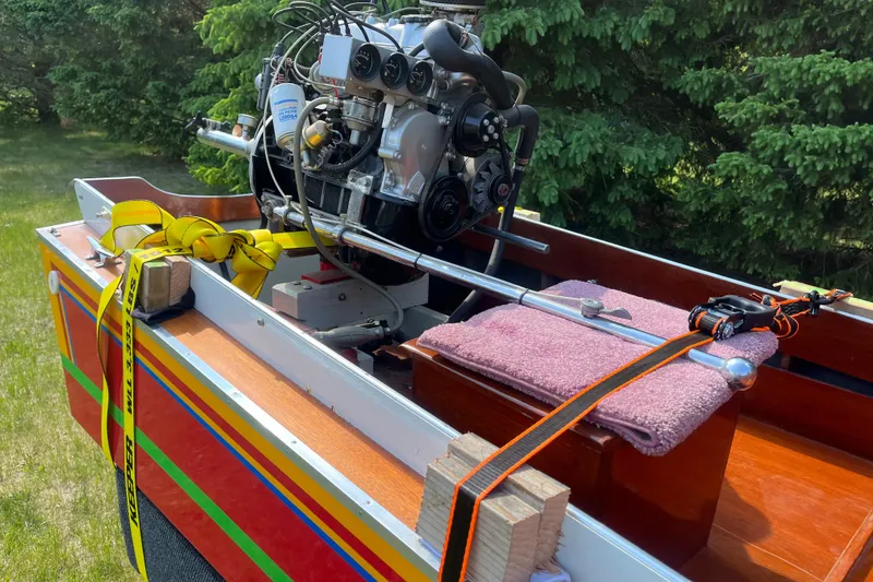 Slide: The Image of 1990 Utility Series Thai Longboat with engine, vibrant stripes, and secured equipment. - 6