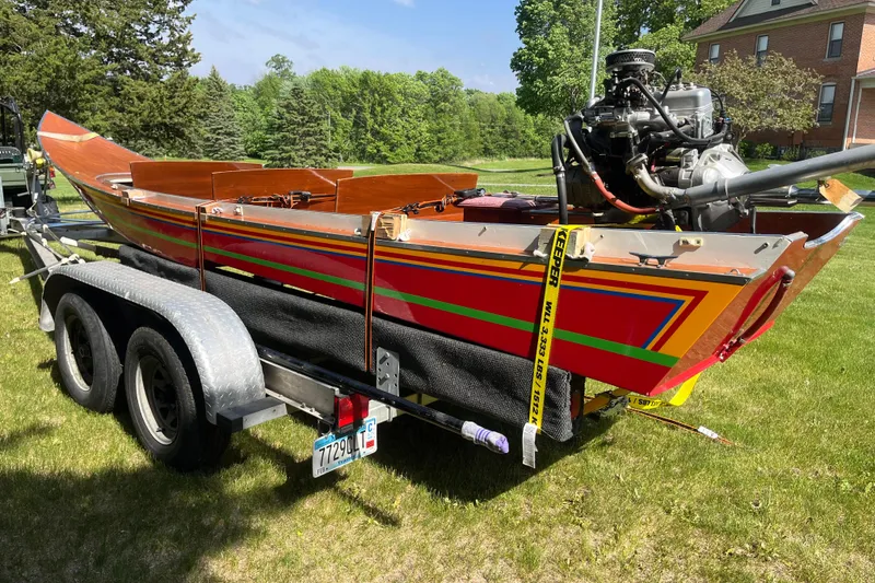 Slide: The Image of Colorful 1990 Utility Series Thai Longboat on trailer, vibrant design, outdoor setting. - 9